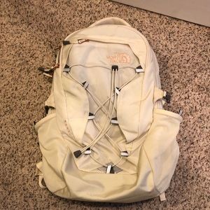 White north face backpack with rose gold metal detailing